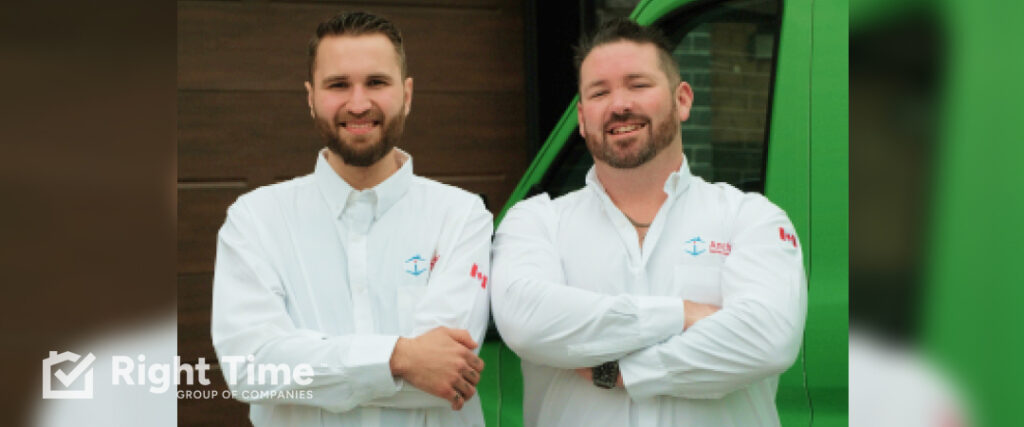 Two Anchor Home Comfort technicians stand smiling with arms crossed beside a green service van outside a home, ready to help Ottawa homeowners with fall furnace vent checks.
